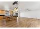Open concept kitchen with island, stainless steel appliances and hardwood floors at 3312 E Flower St, Phoenix, AZ 85018