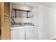Laundry room with washer, dryer, and built-in shelves at 3312 E Flower St, Phoenix, AZ 85018