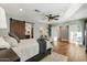 Main bedroom with wood floors, barn door, and ceiling fan at 3446 N 14Th Pl, Phoenix, AZ 85014