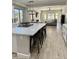 Open concept kitchen with island, white cabinets, and modern appliances at 3957 E Expedition Way, Phoenix, AZ 85050