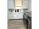 Bright laundry room with white cabinets and modern washer/dryer at 3957 E Expedition Way, Phoenix, AZ 85050