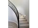 Modern curved staircase with black metal railing at 3957 E Expedition Way, Phoenix, AZ 85050