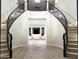 Grand curved staircase with wrought iron railing at 3957 E Expedition Way, Phoenix, AZ 85050