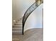 Modern curved staircase with black metal railing at 3957 E Expedition Way, Phoenix, AZ 85050