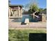 Inviting swimming pool with diving board, water features, and pergola at 3957 E Expedition Way, Phoenix, AZ 85050