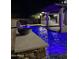 Stunning pool at night with blue lighting and water features at 3957 E Expedition Way, Phoenix, AZ 85050
