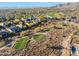 Aerial view of a community with a golf course and a lake at 41007 N Harbour Town Way, Anthem, AZ 85086