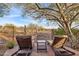 Relaxing backyard patio with lounge chairs and a view of desert landscape at 41007 N Harbour Town Way, Anthem, AZ 85086