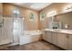 Elegant bathroom with double vanity, soaking tub, and walk-in shower at 41007 N Harbour Town Way, Anthem, AZ 85086