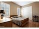 Bright bedroom with wood floors and plantation shutters at 41007 N Harbour Town Way, Anthem, AZ 85086