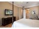 Spacious bedroom with a large bed, dresser, and ensuite bathroom access at 41007 N Harbour Town Way, Anthem, AZ 85086