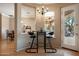 Cozy breakfast nook with a round table and two black barstools, near patio access at 41007 N Harbour Town Way, Anthem, AZ 85086