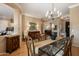 Elegant dining room with hardwood floors and a glass-top table, offering ample space at 41007 N Harbour Town Way, Anthem, AZ 85086