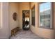 Welcoming entryway with a wood bench and view into the dining room at 41007 N Harbour Town Way, Anthem, AZ 85086