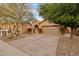 Two-car garage with attractive landscaping and desert plants at 41007 N Harbour Town Way, Anthem, AZ 85086