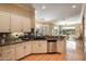 Modern kitchen boasts granite counters, white cabinets, and a spacious layout at 41007 N Harbour Town Way, Anthem, AZ 85086