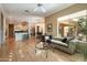 Open living room with hardwood floors, comfortable seating, and views to kitchen at 41007 N Harbour Town Way, Anthem, AZ 85086