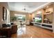 Bright and spacious living room with built-in shelving and hardwood floors at 41007 N Harbour Town Way, Anthem, AZ 85086