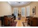 Dedicated music room with hardwood floors, multiple keyboards, and large windows at 41007 N Harbour Town Way, Anthem, AZ 85086