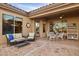 Covered patio with seating area, dining table, and storage shelving at 41007 N Harbour Town Way, Anthem, AZ 85086