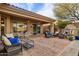 Large covered patio with comfortable seating and dining areas at 41007 N Harbour Town Way, Anthem, AZ 85086