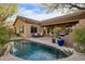 Inviting pool with spacious patio, comfortable seating, and lush landscaping at 41007 N Harbour Town Way, Anthem, AZ 85086