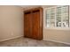 Room with built-in wooden storage cabinet and tile floors at 41007 N Harbour Town Way, Anthem, AZ 85086