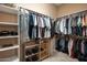 Large walk-in closet with ample shelving and hanging space at 41007 N Harbour Town Way, Anthem, AZ 85086