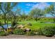 Scenic view of a green landscape with a pond and a rock waterfall at 41007 N Harbour Town Way, Anthem, AZ 85086