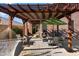 Relaxing backyard patio with pergola, seating, and hammock at 42949 N Voyage Trl, Phoenix, AZ 85086