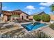 Inviting backyard oasis with a sparkling pool and relaxing patio area at 42949 N Voyage Trl, Phoenix, AZ 85086