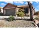 Charming single-story home with a well-manicured front yard at 42949 N Voyage Trl, Phoenix, AZ 85086