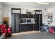 Garage with built-in storage cabinets and work bench at 42949 N Voyage Trl, Phoenix, AZ 85086