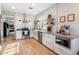 Modern kitchen featuring white cabinets, stainless steel appliances, and light wood flooring at 42949 N Voyage Trl, Phoenix, AZ 85086