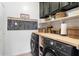 Laundry room with washer, dryer, and built-in wooden shelving at 42949 N Voyage Trl, Phoenix, AZ 85086
