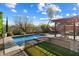 Inviting pool area with pergola, patio furniture, and grassy area at 42949 N Voyage Trl, Phoenix, AZ 85086