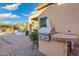 Built-in BBQ with brick counter and ample space for outdoor cooking at 4516 E Madre Del Oro Dr, Cave Creek, AZ 85331