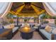 Covered patio with fire pit and comfortable seating at 4516 E Madre Del Oro Dr, Cave Creek, AZ 85331