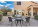 Relaxing backyard patio with seating area, mature plants, and brick pavers at 4516 E Madre Del Oro Dr, Cave Creek, AZ 85331