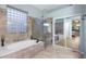 Spa-like bathroom with soaking tub, walk-in shower, and glass enclosure at 4516 E Madre Del Oro Dr, Cave Creek, AZ 85331