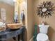 Powder room with vessel sink, decorative mirror, and toilet at 4516 E Madre Del Oro Dr, Cave Creek, AZ 85331