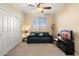 Bedroom with a couch, TV, and ample closet space at 4516 E Madre Del Oro Dr, Cave Creek, AZ 85331