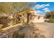 Two-story house with desert landscaping and a three-car garage at 4516 E Madre Del Oro Dr, Cave Creek, AZ 85331