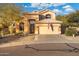 Two-story house with desert landscaping and a three-car garage at 4516 E Madre Del Oro Dr, Cave Creek, AZ 85331
