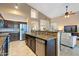 Open kitchen with granite island, stainless steel appliances, and breakfast bar at 4516 E Madre Del Oro Dr, Cave Creek, AZ 85331
