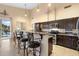 Open kitchen with granite island, stainless steel appliances, and breakfast bar at 4516 E Madre Del Oro Dr, Cave Creek, AZ 85331