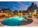 Large freeform pool with surrounding landscaping and patio at 4516 E Madre Del Oro Dr, Cave Creek, AZ 85331