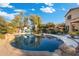 Stunning kidney shaped pool with ample patio space for relaxation at 4516 E Madre Del Oro Dr, Cave Creek, AZ 85331