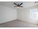 Spacious bedroom with ceiling fan and neutral colored carpet at 4720 E Belleview St, Phoenix, AZ 85008