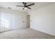 Bright bedroom with carpet flooring, double closet, and ceiling fan at 4720 E Belleview St, Phoenix, AZ 85008